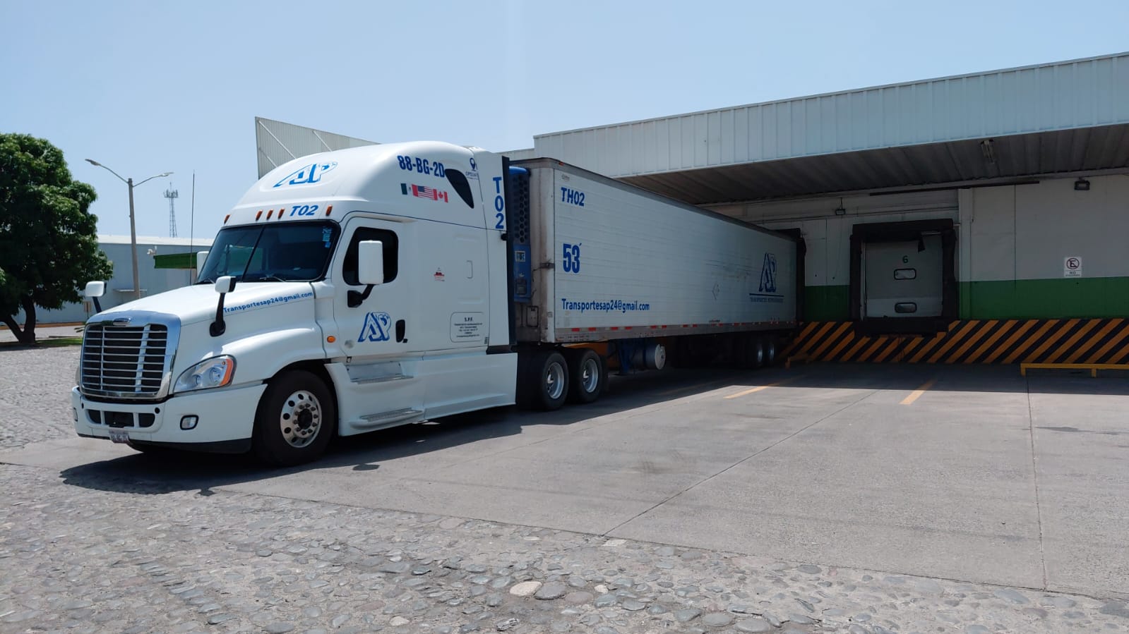 Unidad blanca de Transportes Refrigerados AP en centro de distribución